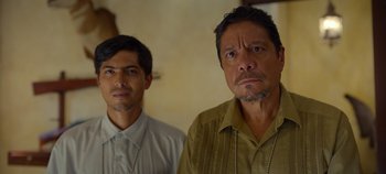 Movie still from “A Deadly Invitation” (2023), directed by J.M Cravioto – Two men standing next to each other in front of a wall; Close Up shot, Low angle