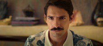 Movie still from “A Deadly Invitation” (2023), directed by J.M Cravioto – A person with a mustache; Close Up shot, Over the shoulder angle