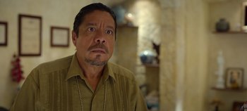 Movie still from “A Deadly Invitation” (2023), directed by J.M Cravioto – A person wearing a brown shirt; Close Up shot, Over the shoulder angle