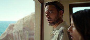 Movie still from “A Deadly Invitation” (2023), directed by J.M Cravioto – A person looking out of a window; Close Up shot, Over the shoulder angle