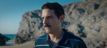 Movie still from “A Deadly Invitation” (2023), directed by J.M Cravioto – A person with a mustache; Close Up shot, Over the shoulder angle