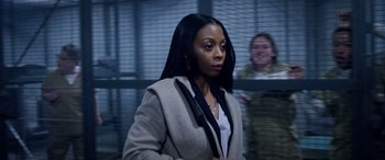 Movie still from “A Fall from Grace” (2020), directed by Tyler Perry – A woman standing in front of a wall; Close Up shot, Over the shoulder angle