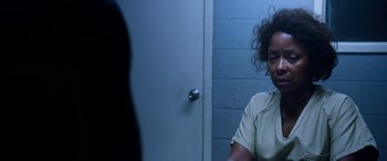 Movie still from “A Fall from Grace” (2020), directed by Tyler Perry – A woman sitting in front of a wall in a room; Close Up shot, Over the shoulder angle