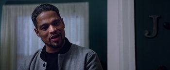 Movie still from “A Fall from Grace” (2020), directed by Tyler Perry – A person wearing a jacket; Close Up shot, Over the shoulder angle