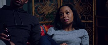 Movie still from “A Fall from Grace” (2020), directed by Tyler Perry – A woman sitting on a couch looking at the camera; Close Up shot, Over the shoulder angle