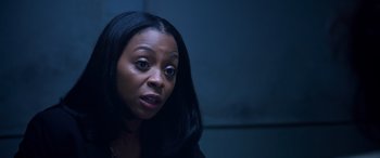 Movie still from “A Fall from Grace” (2020), directed by Tyler Perry – A woman with long black hair is looking at the camera; Close Up shot, High angle