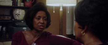 Movie still from “A Fall from Grace” (2020), directed by Tyler Perry – An older black woman sitting in front of a lamp; Close Up shot, Over the shoulder angle
