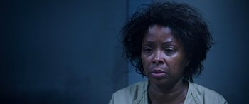 Movie still from “A Fall from Grace” (2020), directed by Tyler Perry – An older woman with black curly hair looking sad; Close Up shot, Low angle