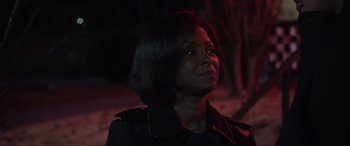 Movie still from “A Fall from Grace” (2020), directed by Tyler Perry – A woman in a black jacket looking up at the sky; Close Up shot, Over the shoulder angle