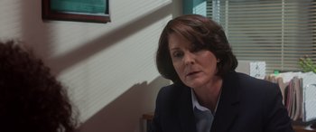 Movie still from “A Fall from Grace” (2020), directed by Tyler Perry – A person wearing a suit and tie; Close Up shot, Over the shoulder angle