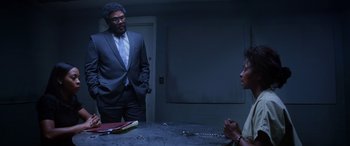 Movie still from “A Fall from Grace” (2020), directed by Tyler Perry – A man and a woman in a dark room; Medium shot, Low angle