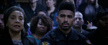 Movie still from “A Fall from Grace” (2020), directed by Tyler Perry – A man in a police uniform looking at the camera; Close Up shot, Over the shoulder angle