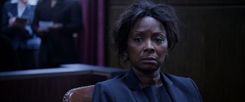 Movie still from “A Fall from Grace” (2020), directed by Tyler Perry – An older woman sitting in a chair looking at the camera; Close Up shot, Over the shoulder angle