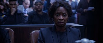 Movie still from “A Fall from Grace” (2020), directed by Tyler Perry – A woman sitting in front of a crowd of people; Close Up shot, Over the shoulder angle