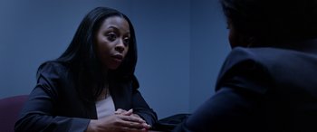 Movie still from “A Fall from Grace” (2020), directed by Tyler Perry – A woman sitting in front of a mirror talking to another person; Close Up shot, Over the shoulder angle