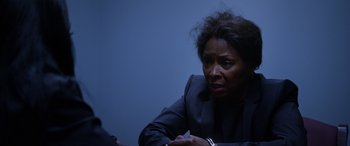 Movie still from “A Fall from Grace” (2020), directed by Tyler Perry – An older woman sitting in front of a blue wall; Close Up shot, Over the shoulder angle