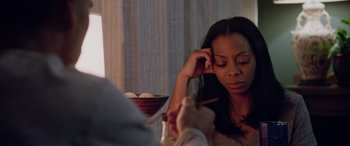 Movie still from “A Fall from Grace” (2020), directed by Tyler Perry – A woman sitting in front of a bowl of eggs; Close Up shot, Over the shoulder angle