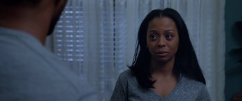 Movie still from “A Fall from Grace” (2020), directed by Tyler Perry – A black woman with long black hair looking at the camera; Close Up shot, Over the shoulder angle