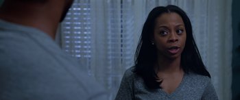 Movie still from “A Fall from Grace” (2020), directed by Tyler Perry – A woman standing in front of a window with her eyes closed; Close Up shot, Over the shoulder angle