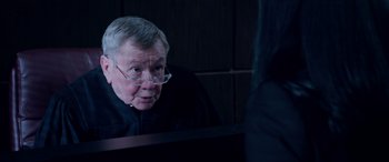 Movie still from “A Fall from Grace” (2020), directed by Tyler Perry – An older man wearing glasses looking in a mirror; Close Up shot, Over the shoulder angle