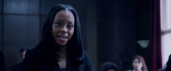 Movie still from “A Fall from Grace” (2020), directed by Tyler Perry – A woman with long black hair smiles for the camera; Close Up shot, High angle