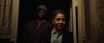 Movie still from “A Fall from Grace” (2020), directed by Tyler Perry – A man and a woman standing next to each other in a room; Close Up shot, Low angle