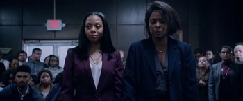 Movie still from “A Fall from Grace” (2020), directed by Tyler Perry – Two women standing next to each other in front of a wall; Medium shot, Low angle