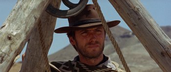 Movie still from “A Fistful of Dollars” (1964), directed by Sergio Leone – A person wearing a hat; Close Up shot, Low angle