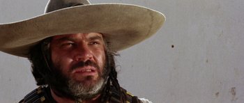 Movie still from “A Fistful of Dollars” (1964), directed by Sergio Leone – A person wearing a hat; Close Up shot, Low angle