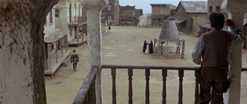 Movie still from “A Fistful of Dollars” (1964), directed by Sergio Leone – An old western town with a few people walking around it; Extreme Wide shot, High angle