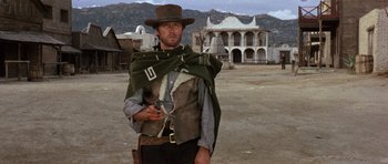 Movie still from “A Fistful of Dollars” (1964), directed by Sergio Leone – A man dressed as clint eastwood from the movie the good , the bad and the ugly; Medium shot, Low angle