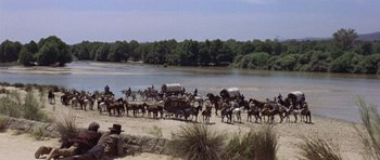 Movie still from “A Fistful of Dollars” (1964), directed by Sergio Leone – A group of people riding horses on top of a sandy beach; Extreme Wide shot, High angle