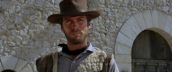 Movie still from “A Fistful of Dollars” (1964), directed by Sergio Leone – A man wearing a hat and a vest; Close Up shot, Low angle