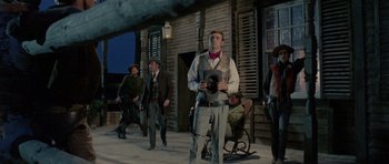 Movie still from “A Fistful of Dollars” (1964), directed by Sergio Leone – A group of men standing on the side of a building; Wide shot, Low angle