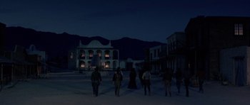 Movie still from “A Fistful of Dollars” (1964), directed by Sergio Leone – A group of people walking in the middle of the night; Extreme Wide shot, Low angle