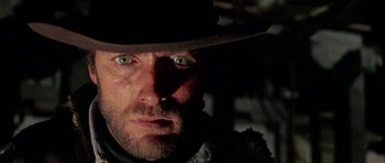 Movie still from “A Fistful of Dollars” (1964), directed by Sergio Leone – A person wearing a hat; Close Up shot, Low angle