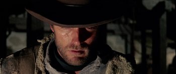 Movie still from “A Fistful of Dollars” (1964), directed by Sergio Leone – A person wearing a hat; Close Up shot, Low angle