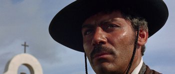 Movie still from “A Fistful of Dollars” (1964), directed by Sergio Leone – A person wearing a hat; Close Up shot, Low angle