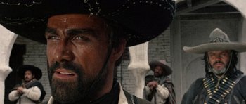 Movie still from “A Fistful of Dollars” (1964), directed by Sergio Leone – A person wearing a cowboy hat; Close Up shot, Low angle