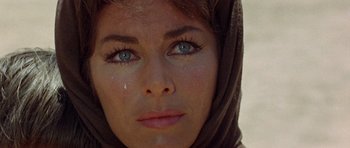 Movie still from “A Fistful of Dollars” (1964), directed by Sergio Leone – A woman's face with tears coming out of her eyes; Close Up shot, High angle