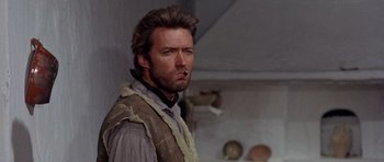 Movie still from “A Fistful of Dollars” (1964), directed by Sergio Leone – A person wearing a vest; Close Up shot, Low angle