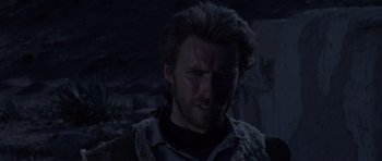 Movie still from “A Fistful of Dollars” (1964), directed by Sergio Leone – A person wearing a vest; Close Up shot, Over the shoulder angle