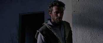 Movie still from “A Fistful of Dollars” (1964), directed by Sergio Leone – A person standing in a room; Close Up shot, Over the shoulder angle