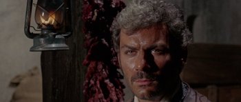 Movie still from “A Fistful of Dollars” (1964), directed by Sergio Leone – A person wearing a suit and tie; Close Up shot, Low angle