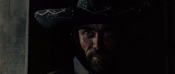 Movie still from “A Fistful of Dollars” (1964), directed by Sergio Leone – A person wearing a cowboy hat; Close Up shot, Low angle