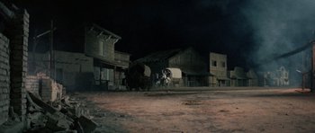 Movie still from “A Fistful of Dollars” (1964), directed by Sergio Leone – An old western town at night with a covered wagon; Extreme Wide shot, Low angle