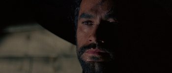 Movie still from “A Fistful of Dollars” (1964), directed by Sergio Leone – A person wearing a hat; Close Up shot, Low angle