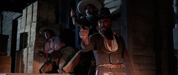 Movie still from “A Fistful of Dollars” (1964), directed by Sergio Leone – Two men dressed in costumes and holding guns; Medium shot, Low angle