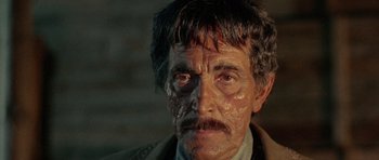 Movie still from “A Fistful of Dollars” (1964), directed by Sergio Leone – A person wearing a jacket; Close Up shot, Over the shoulder angle