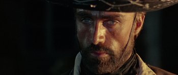 Movie still from “A Fistful of Dollars” (1964), directed by Sergio Leone – A person wearing a hat; Close Up shot, Over the shoulder angle